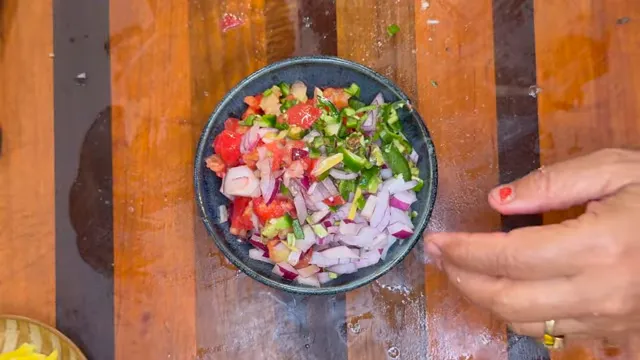 Bowl of chopped tomatoes red onion green chili coriander and ginger