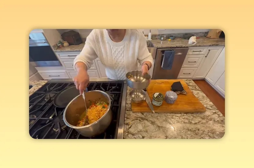 Yellow dried peas being poured into a pot of vegetables and barley