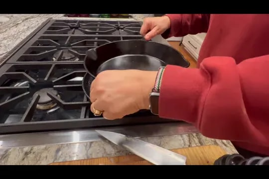 Sandwich pressed between two cast iron skillets on a stovetop