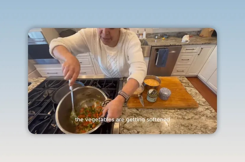 Vegetables softening in olive oil inside a stainless steel pot
