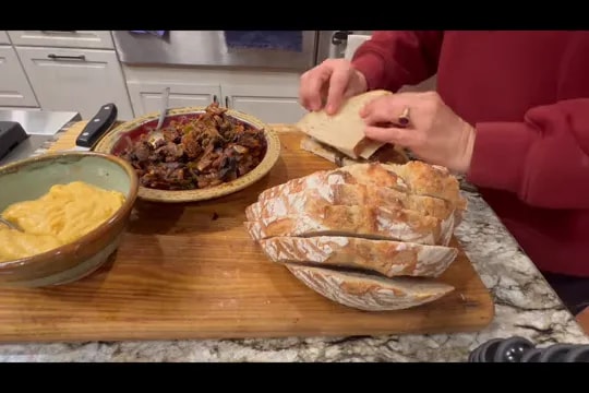 Bread slices, vegan cheese, and mushroom filling arranged on a cutting board