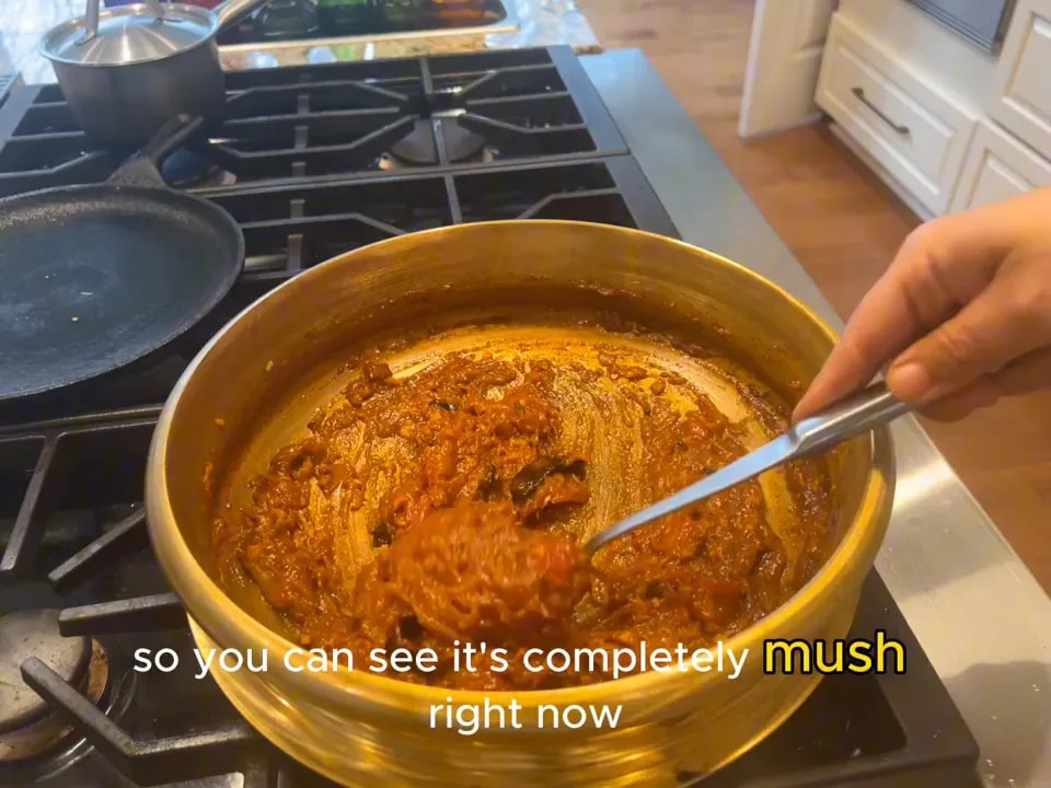 Thick reddish onion and tomato curry base in a wide pan